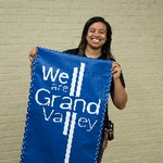 Girl holding "We are Grand Valley" banner